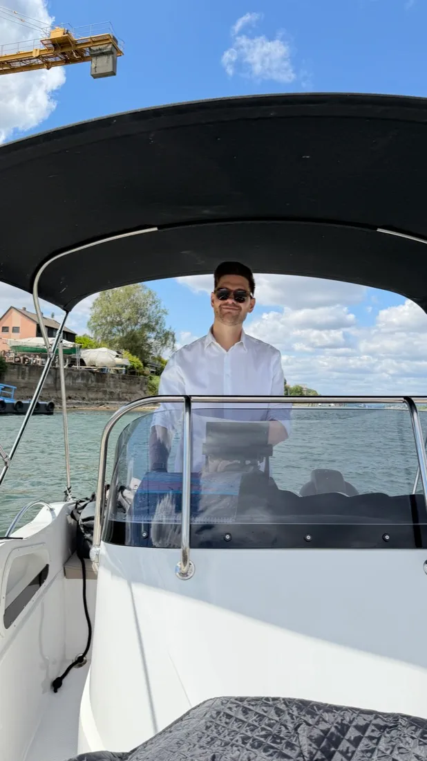 Julian steering a boat on the Rhine