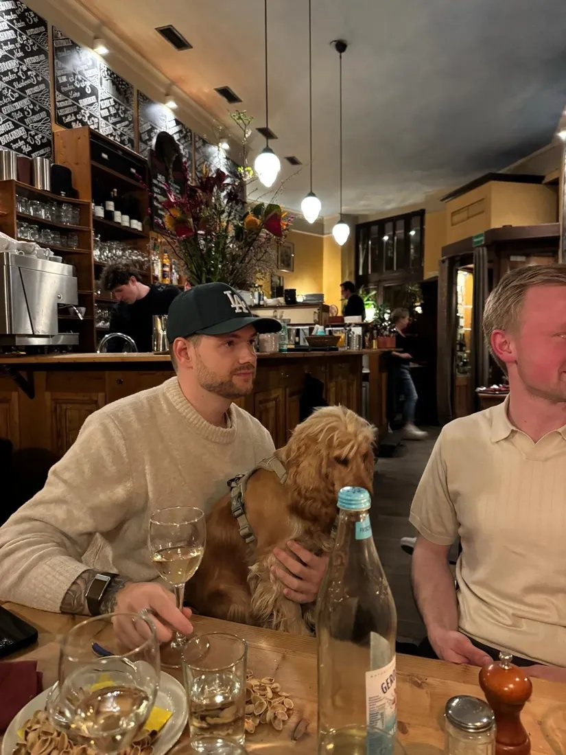 Julian in a pub with a dog on his lap