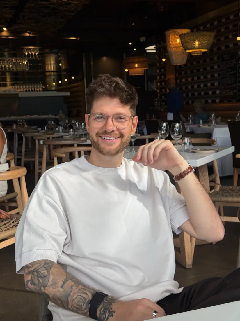 Julian laughing at a restaurant table