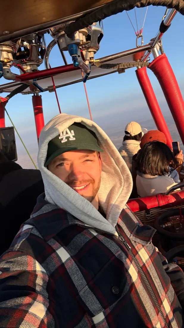 Julian in a hot air balloon at sunrise